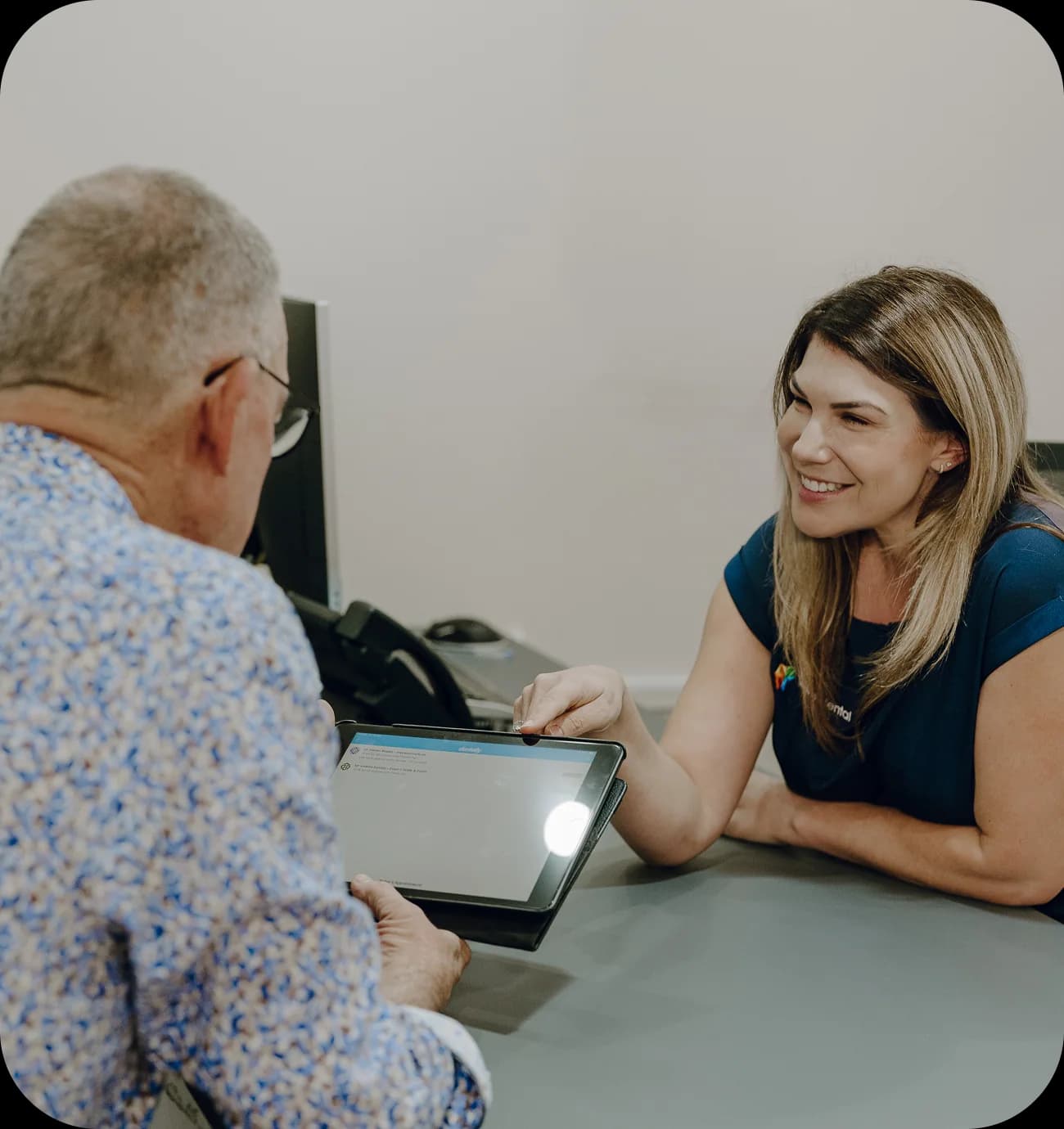 Dentist explaining scan details with a patient during a consultation