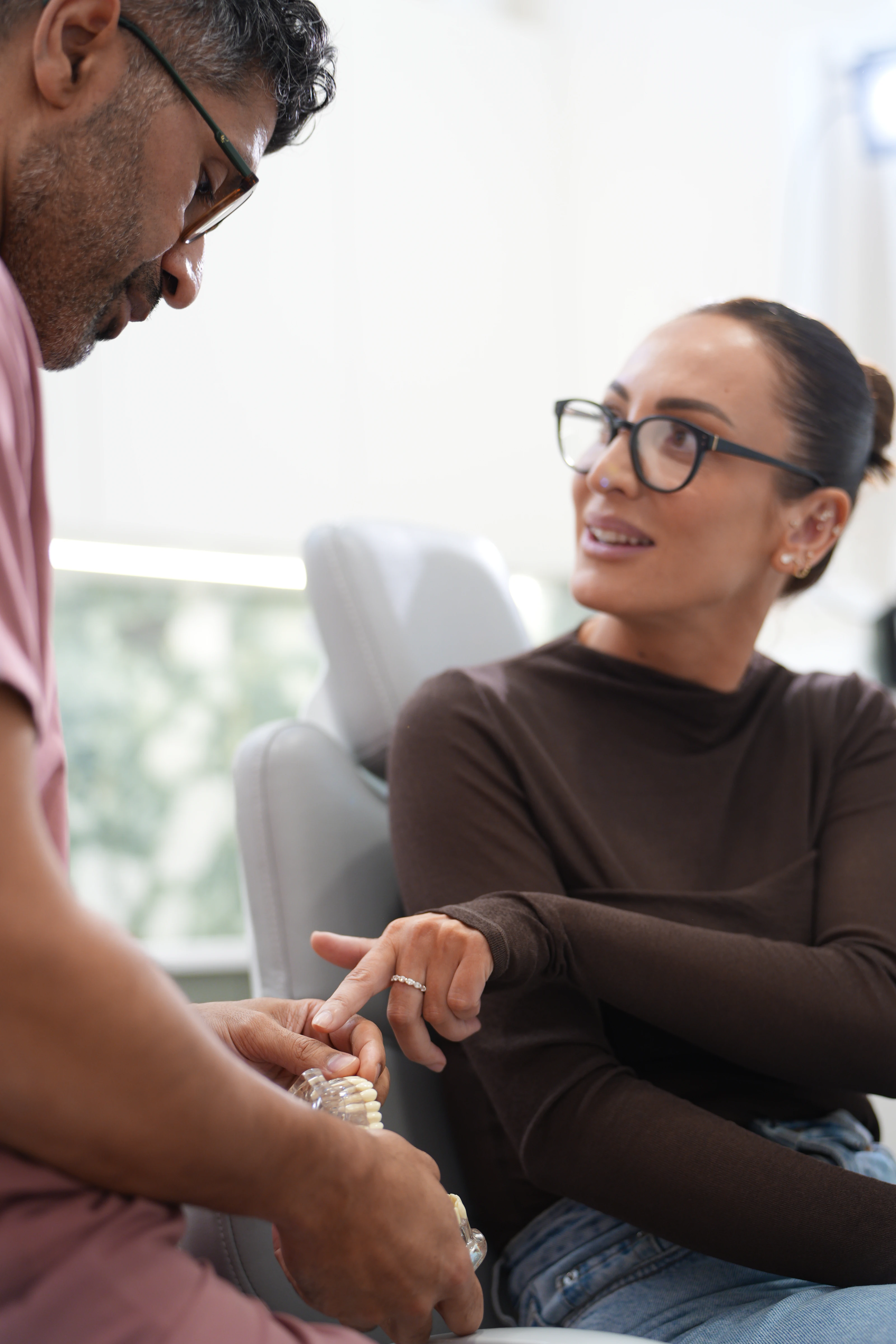 Dentist reviewing records with a patient during a new patient appointment