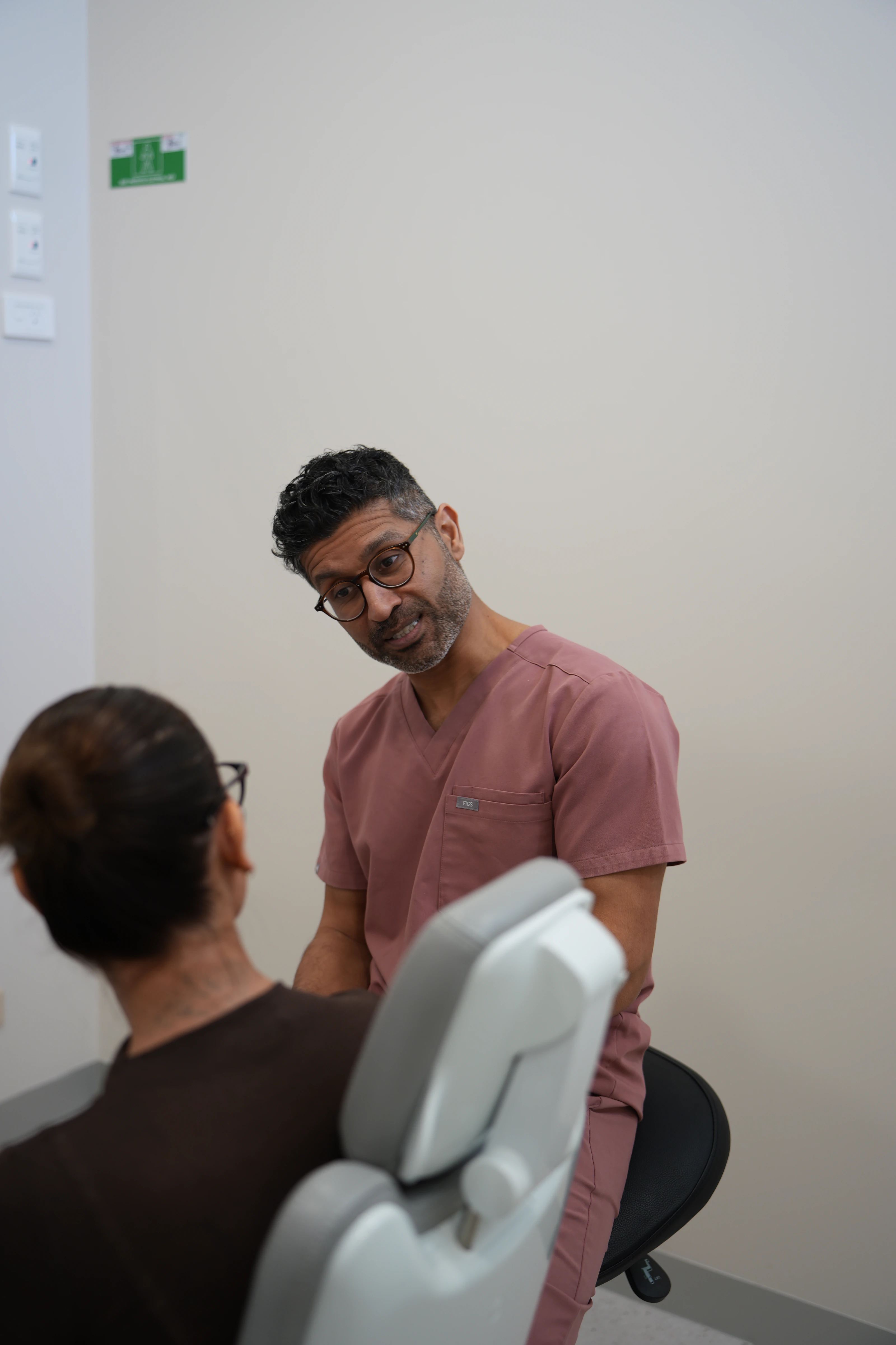 Patient sitting in the dental studio before discussing questions with the clinician