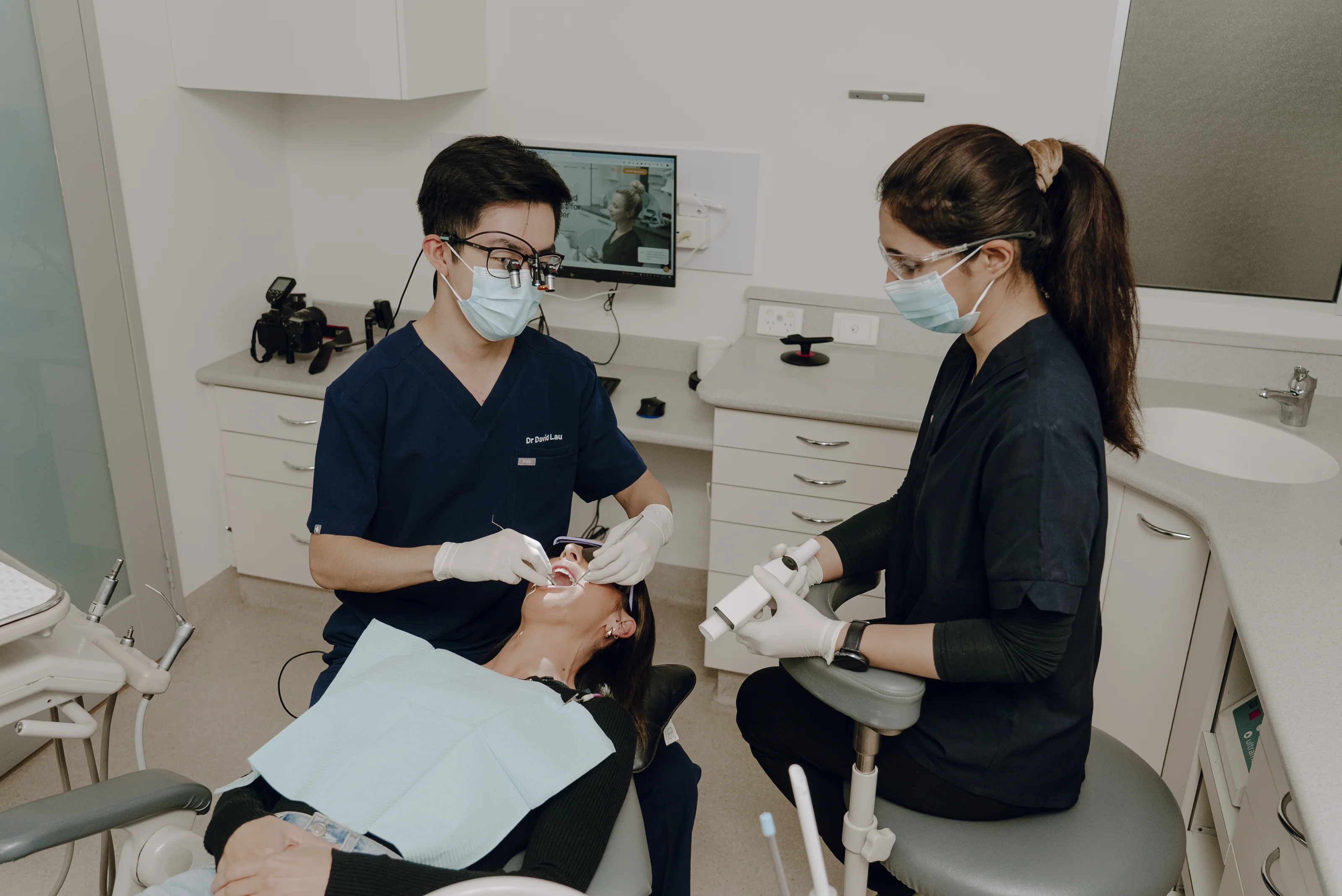 Dental clinicians completing an assessment before treatment planning
