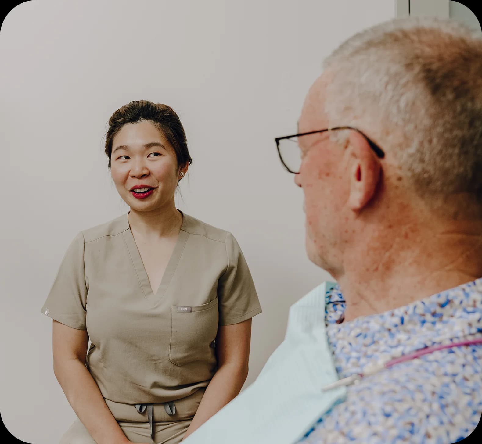 A dentist reviewing full arch implant planning imagery with a patient