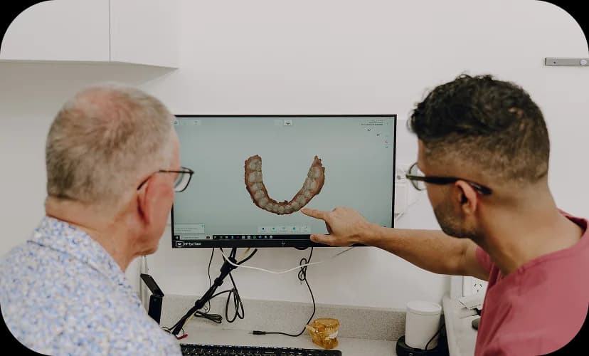 A dental clinician reviewing implant planning records