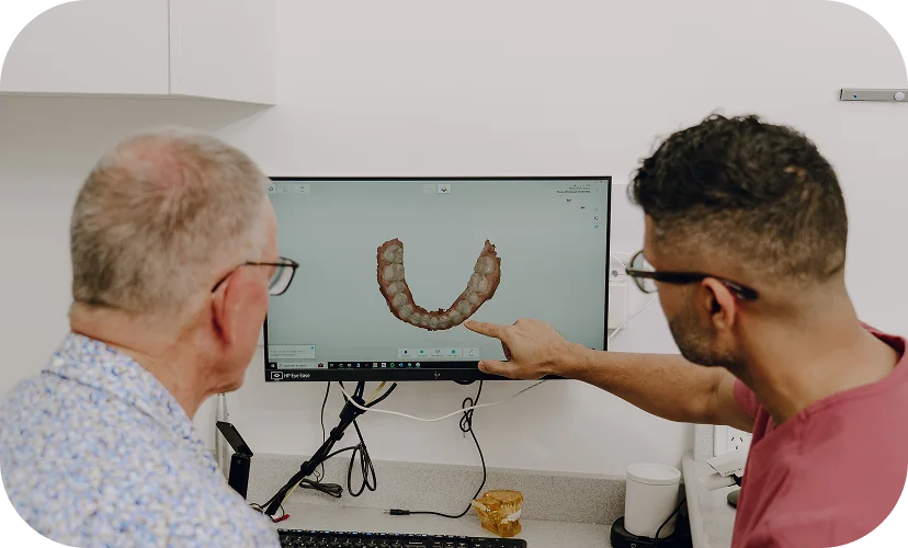 A dental clinician reviewing implant planning records