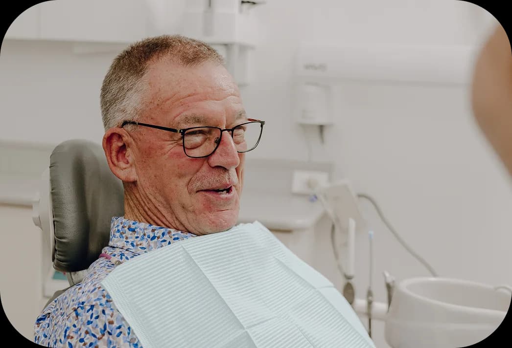 A dentist reviewing full arch implant planning imagery with a patient