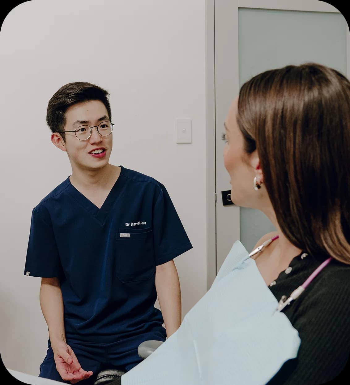 A patient smiling during a dental implant consultation