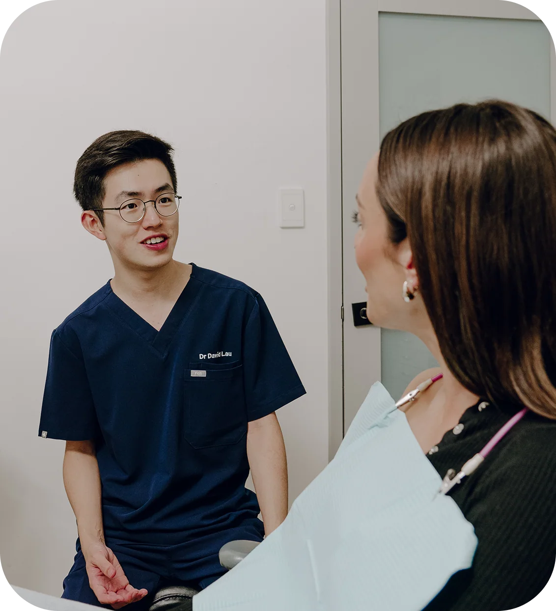 A patient smiling during a dental implant consultation