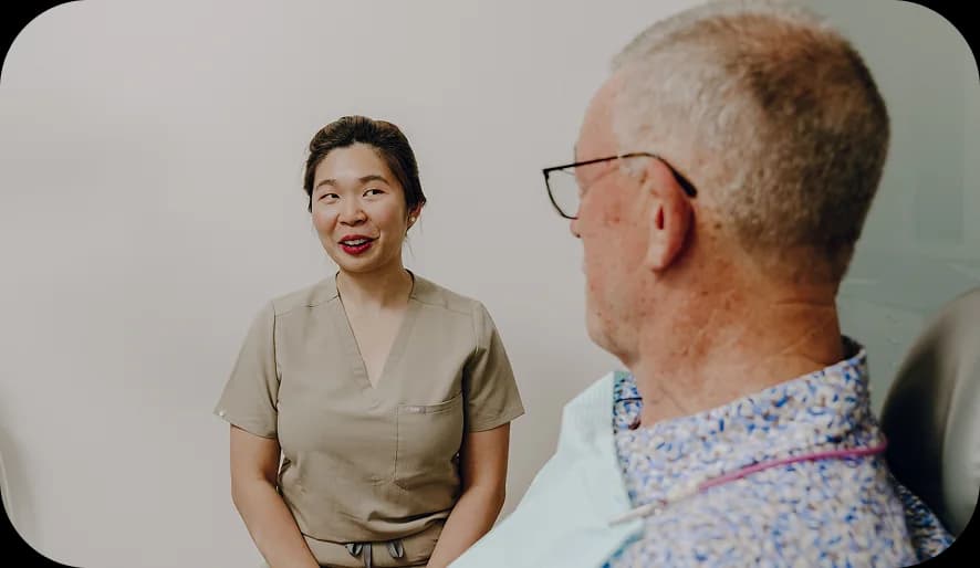 A patient and dentist reviewing digital implant planning together