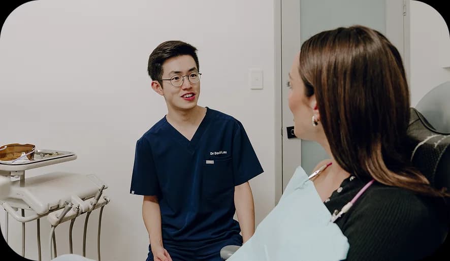 A patient smiling during a dental implant consultation