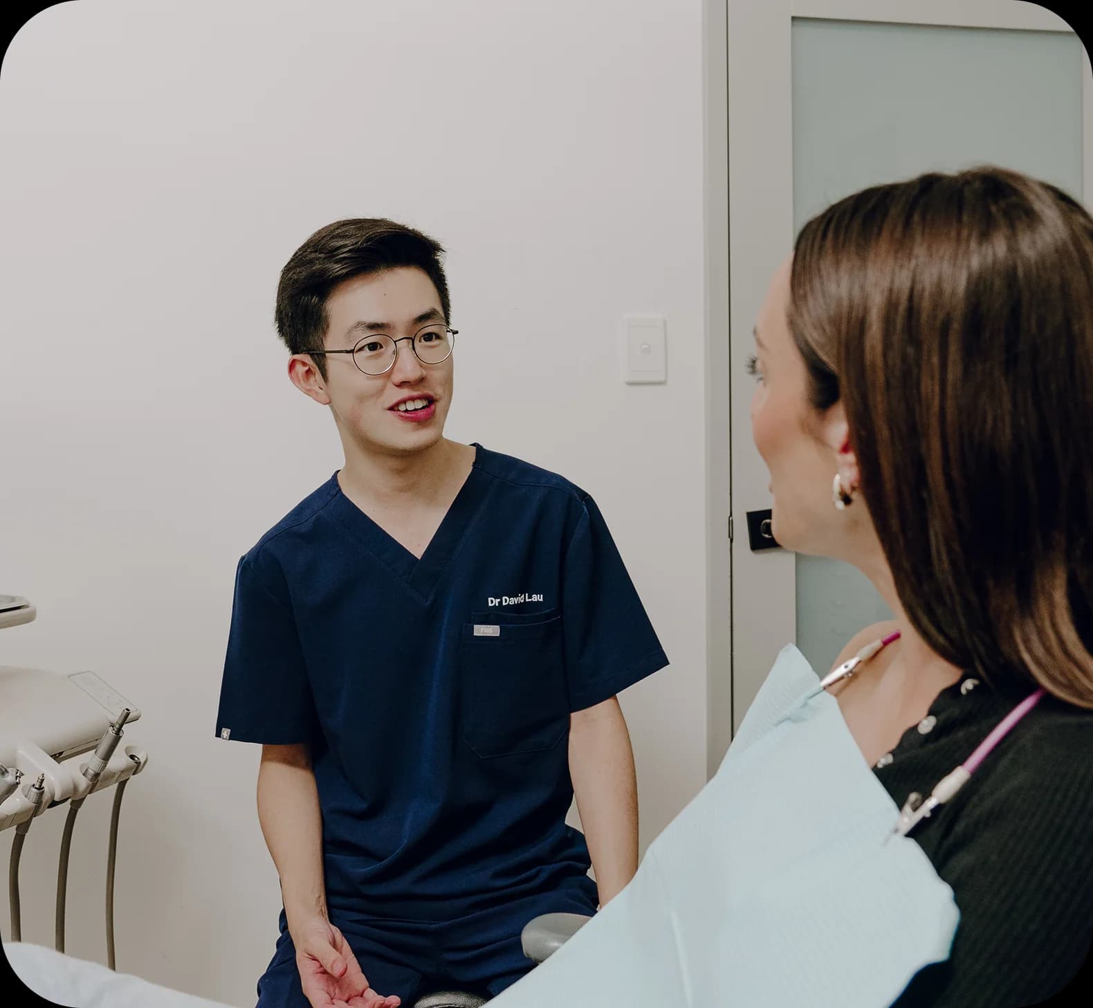 A patient smiling during a dental implant consultation