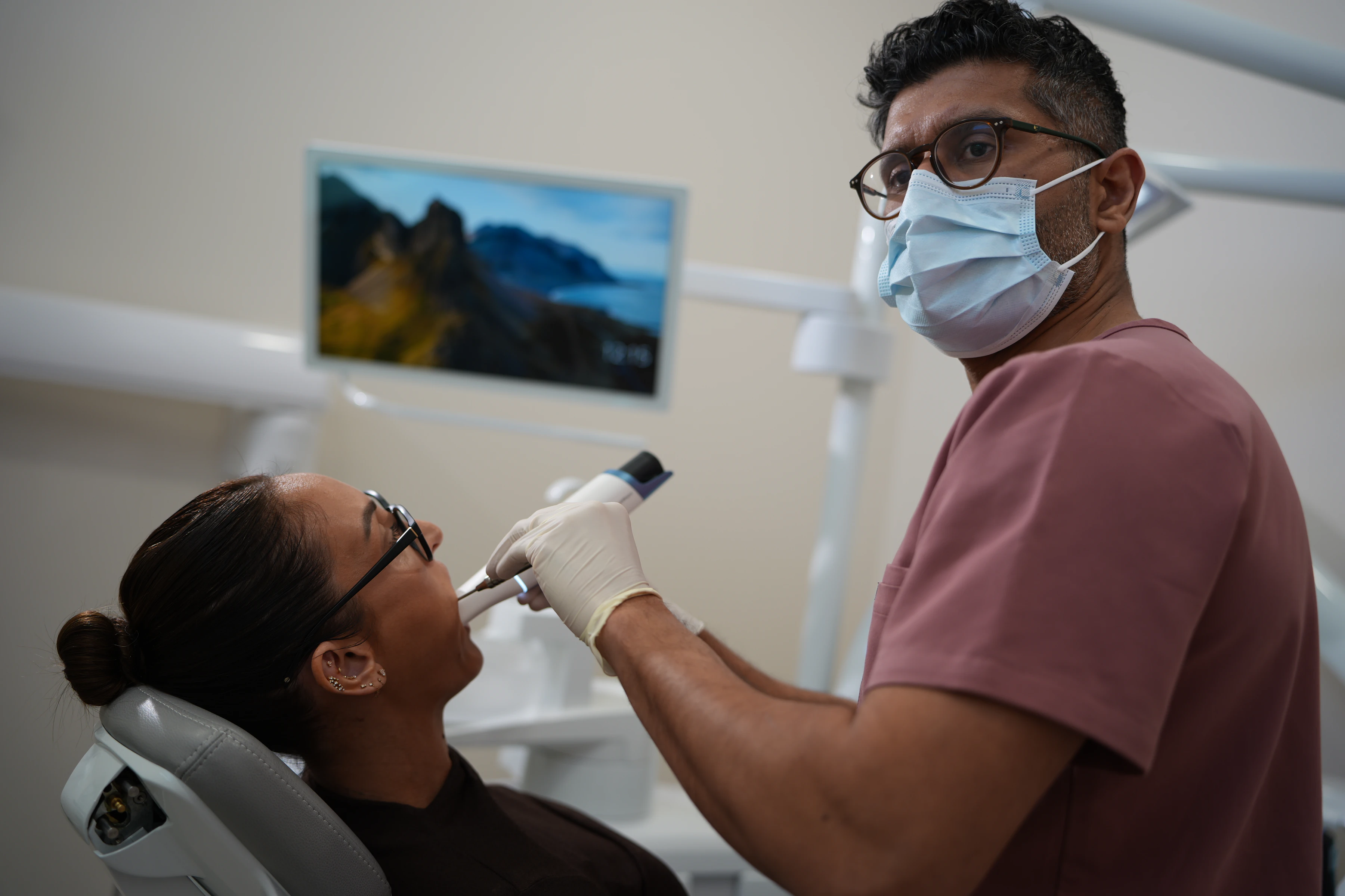 Dentist providing single tooth implant care in a clinical room